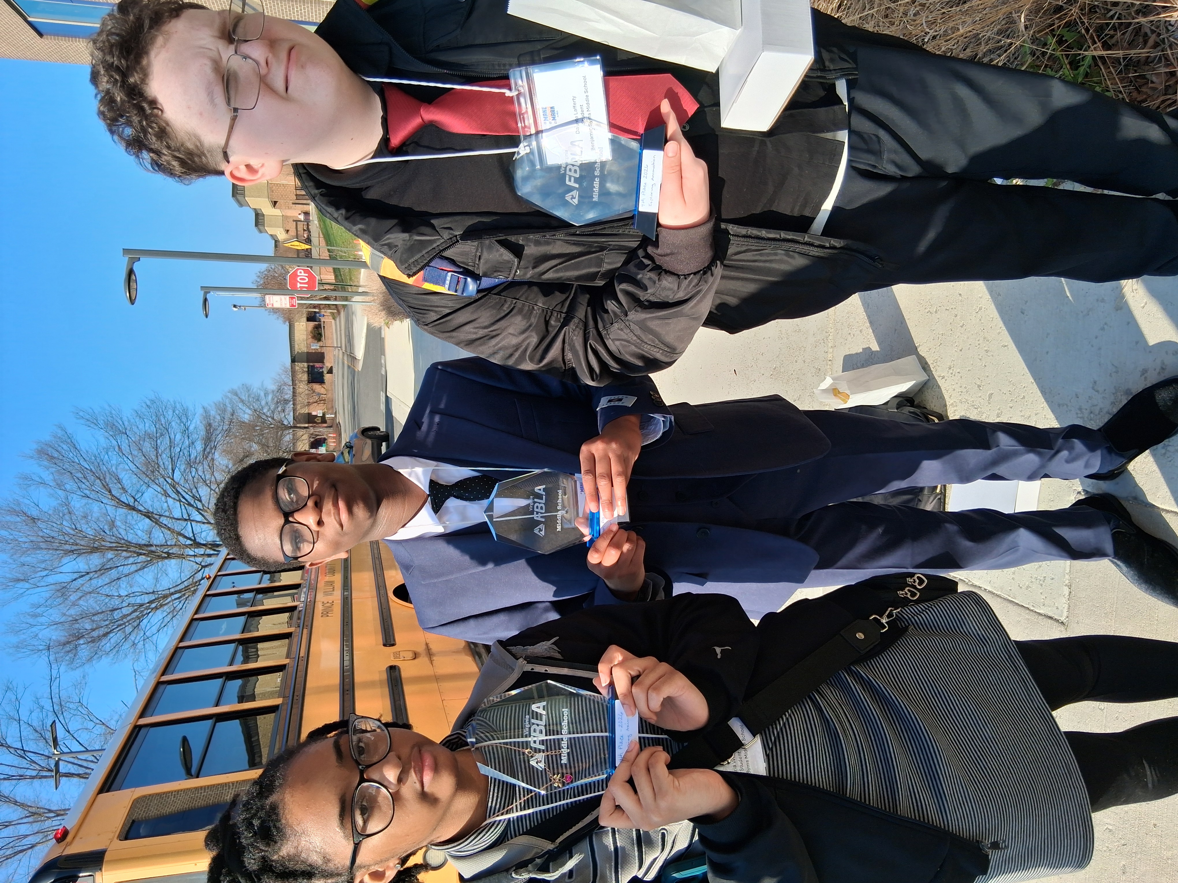 Syms FBLA holding trophies